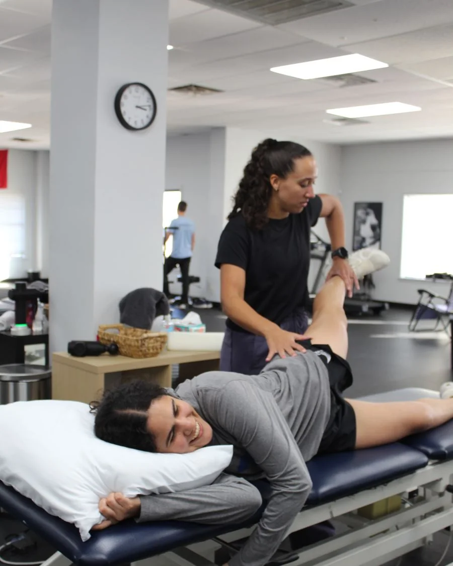 A patient working through hip mobility and strength exercises with a Vitality coach