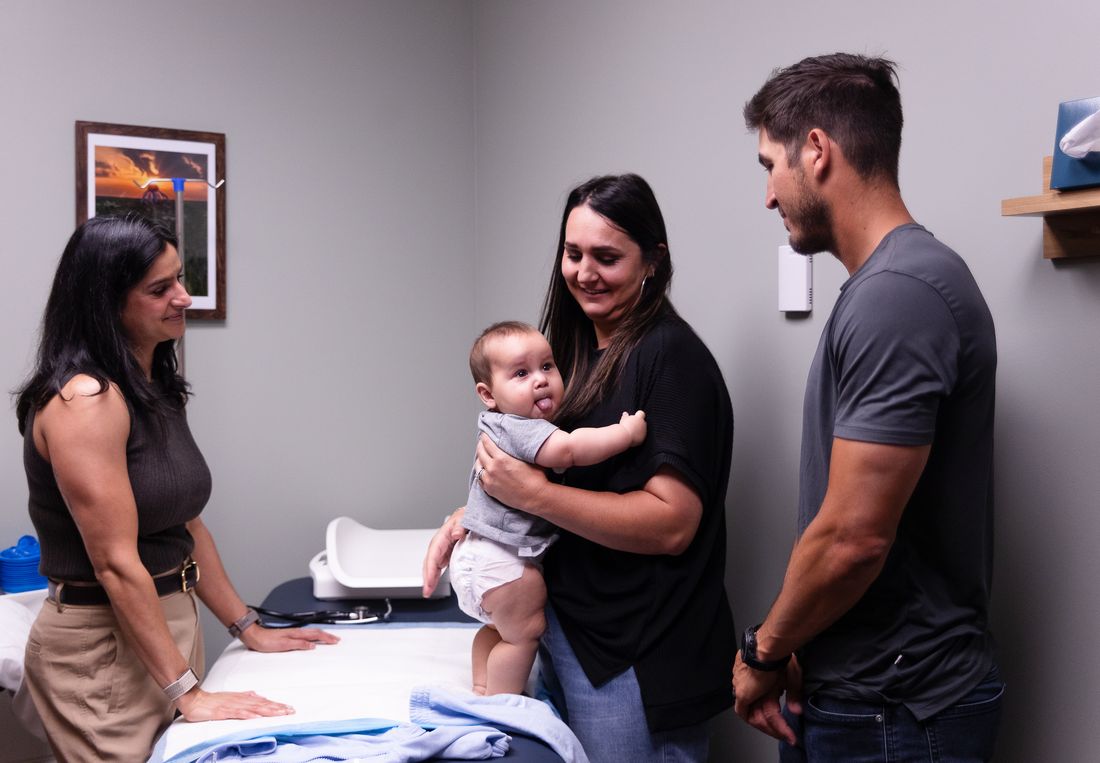 Vitality Functional Family Medicine physician checking in with a family and their baby