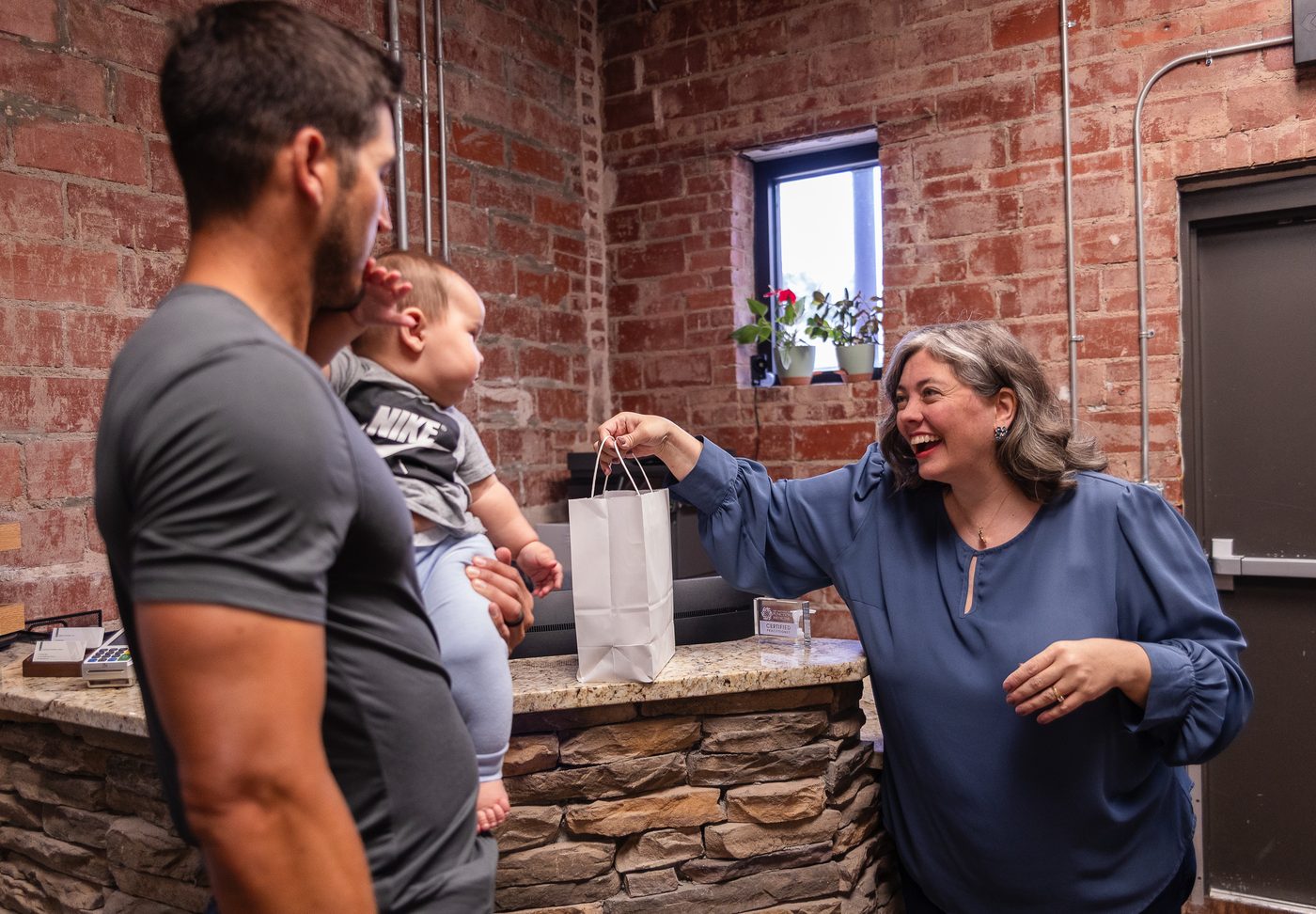 Vitality Functional Family Medicine team member welcoming a patient at check-in