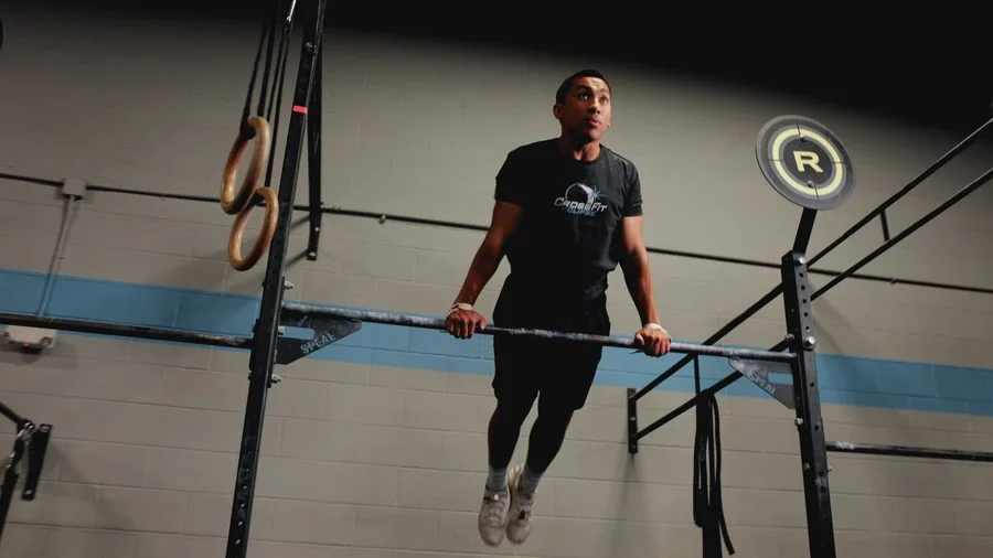 A patient doing a deadlift or hip-hinge exercise at Vitality Therapy and Performance
