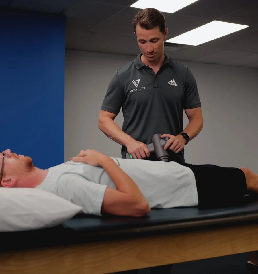 Manual percussion treatment at Vitality Therapy and Performance